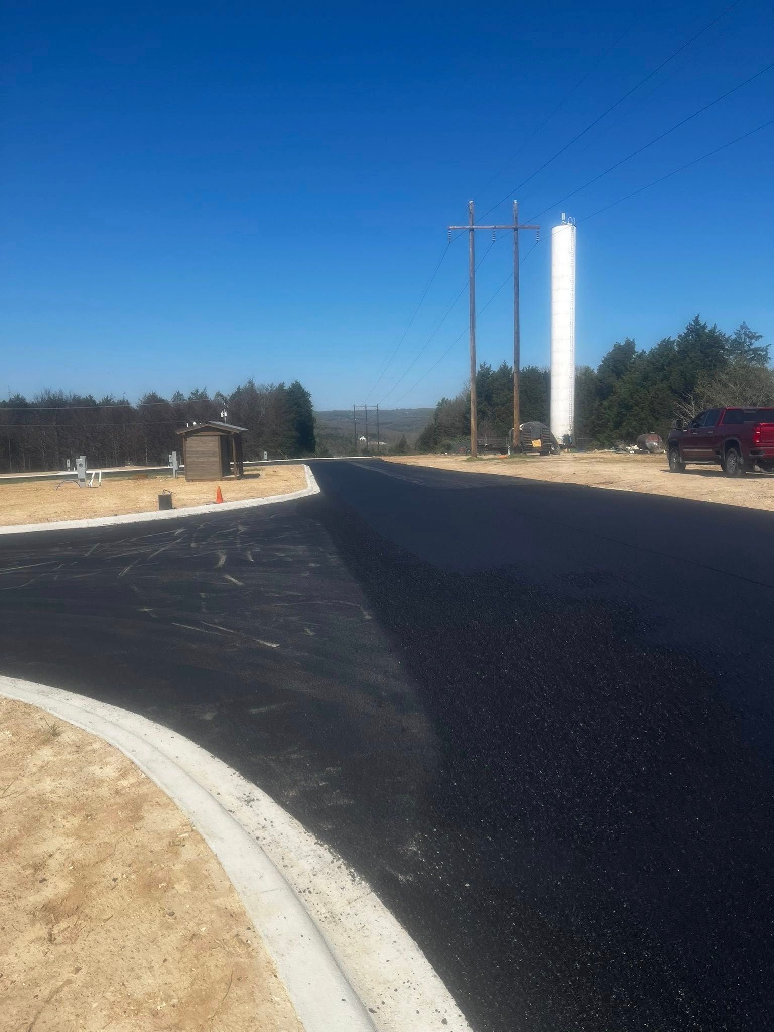 A red truck is parked on the side of a road.