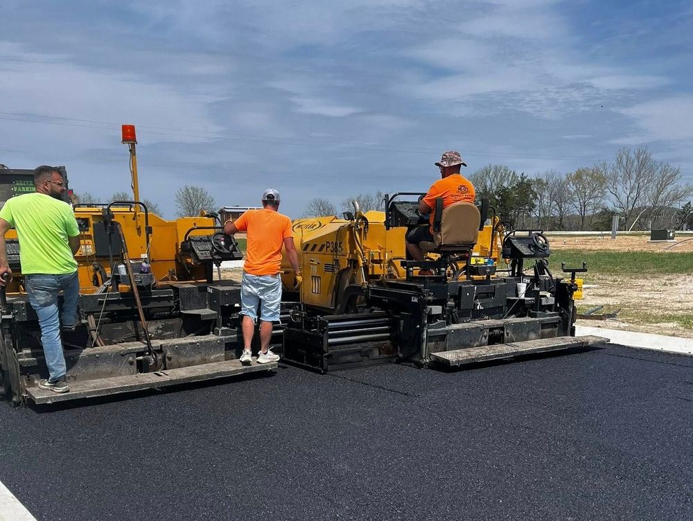 A group of construction workers are working on a road.