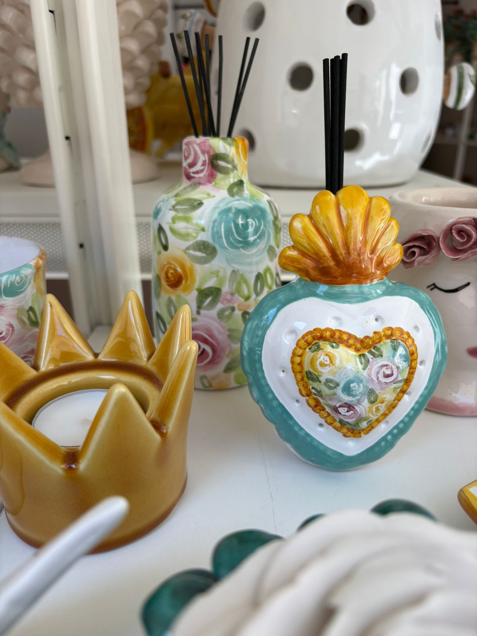 Una dozzina di pasticcini in miniatura in ceramica su un vassoio grigio decorativo.