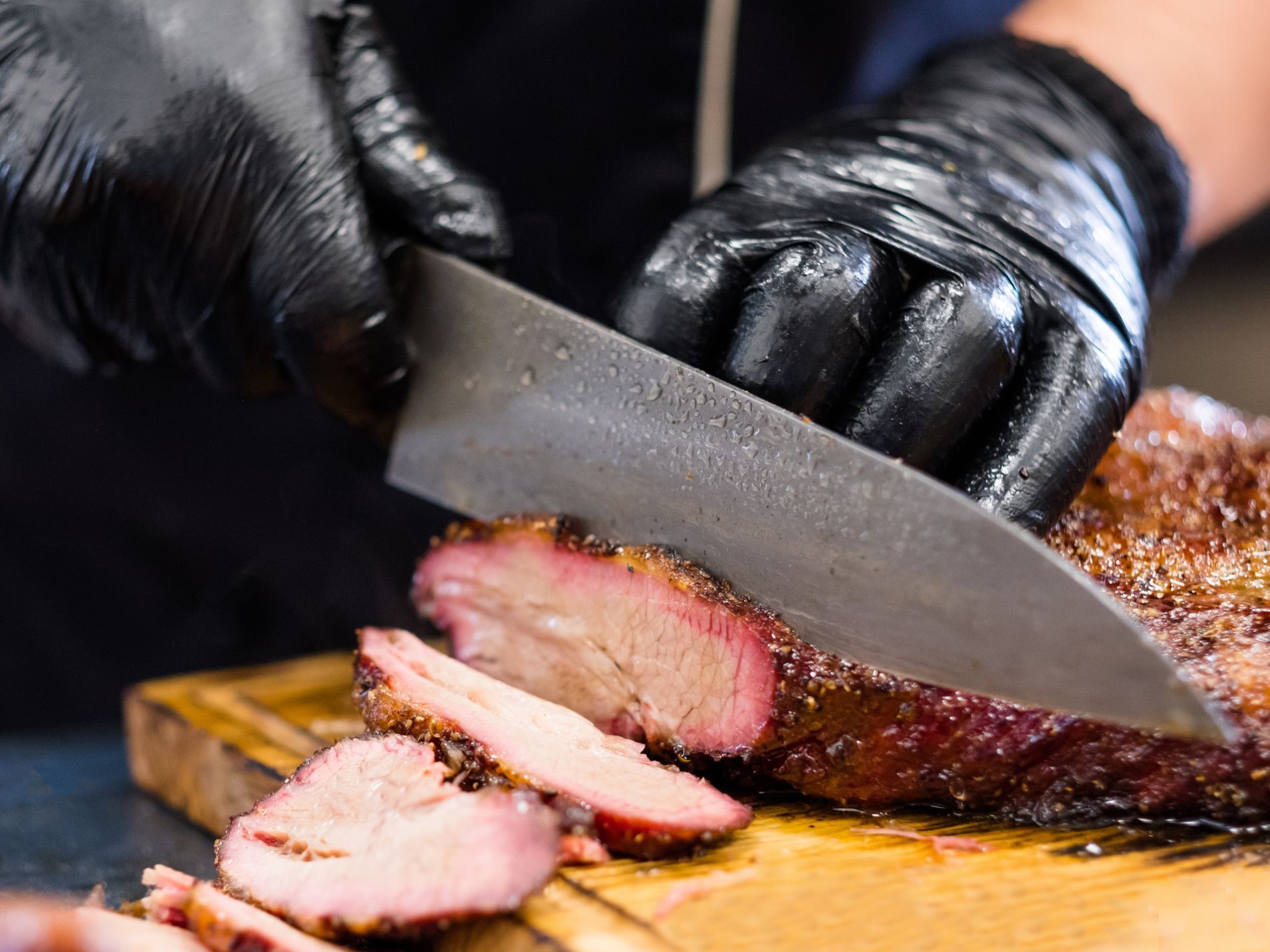 Chef cutting slices of roast meat