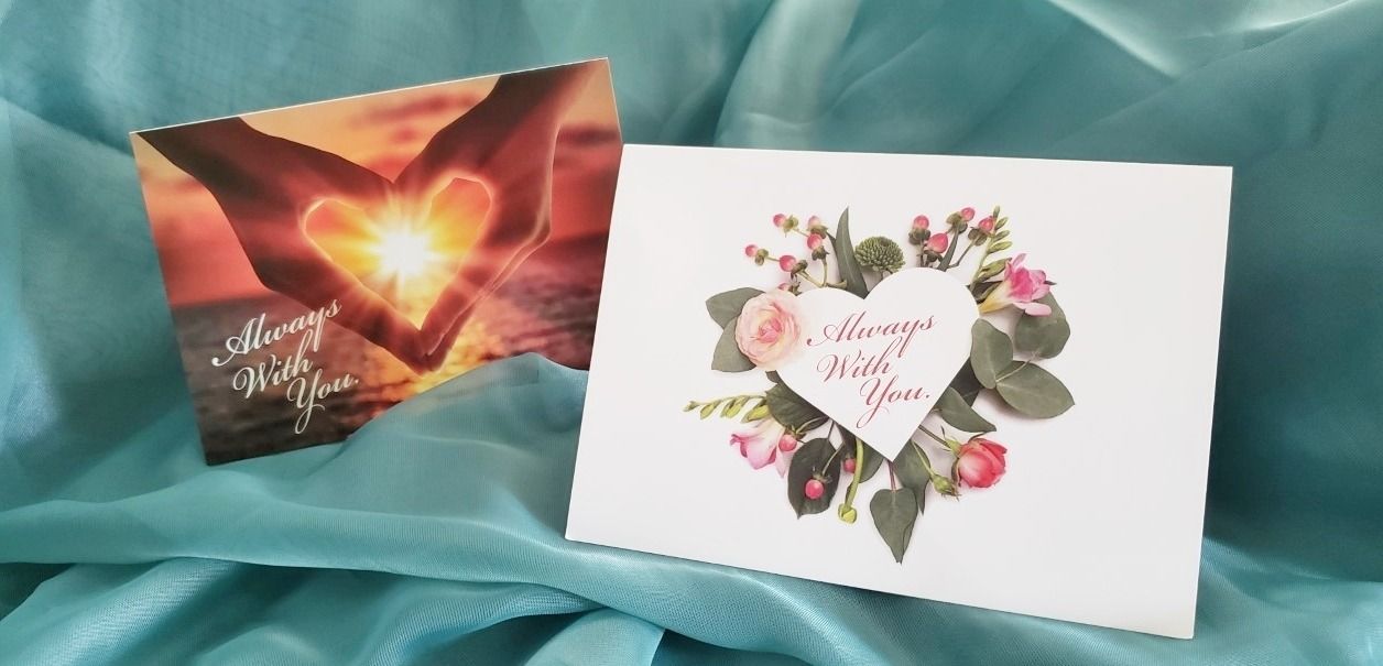 A couple of cards sitting on top of a blue cloth.