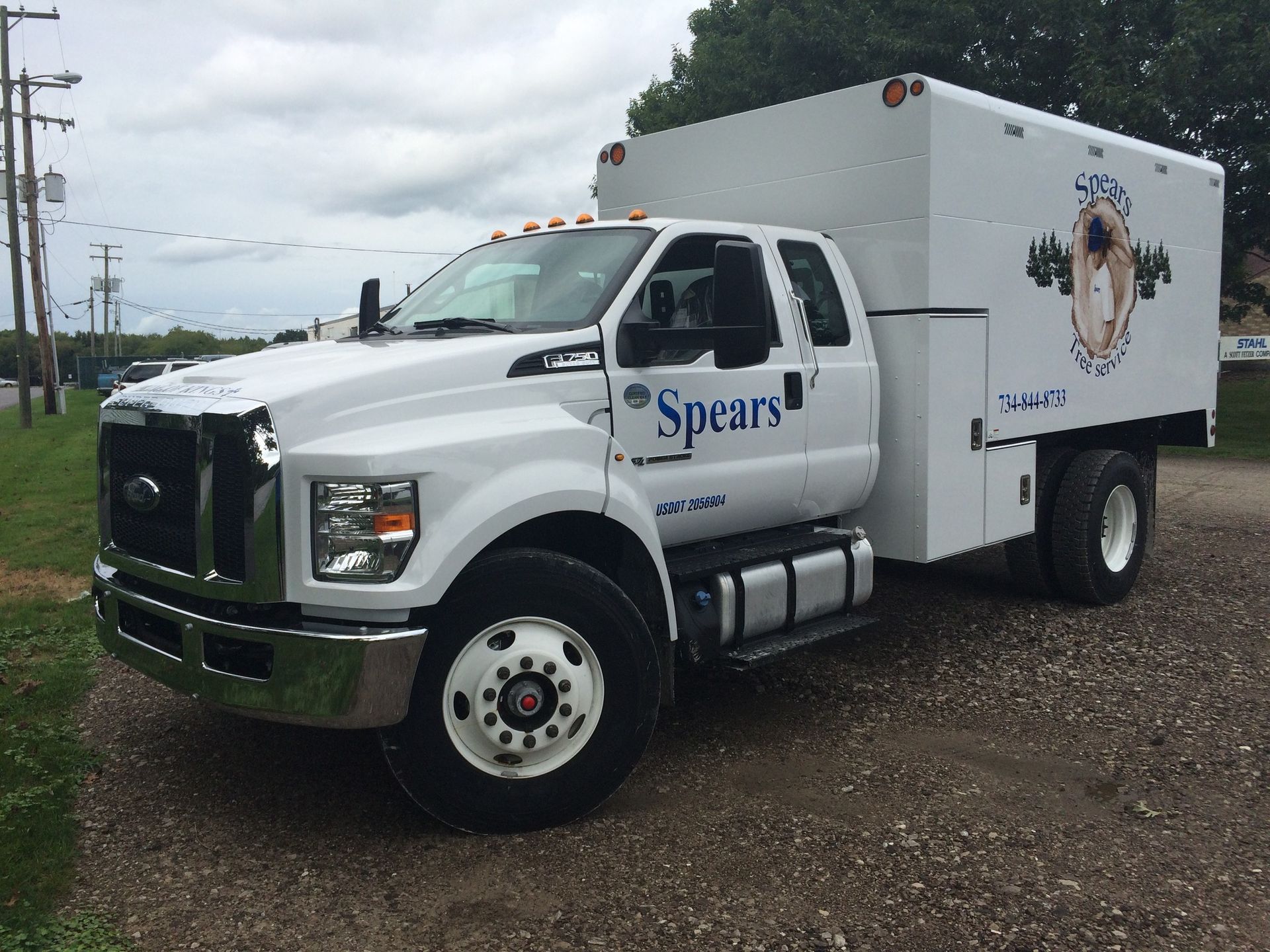 White Spears utility truck parked on gravel.