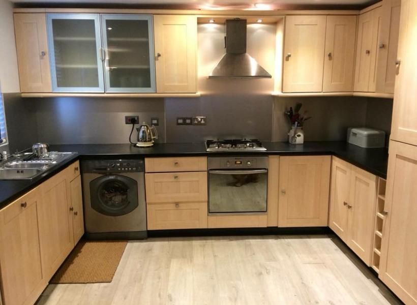 A kitchen with wooden cabinets and stainless steel appliances