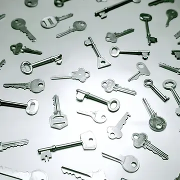 A bunch of silver keys on a white surface