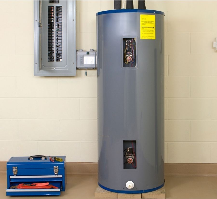 A gray water heater is sitting next to a blue toolbox