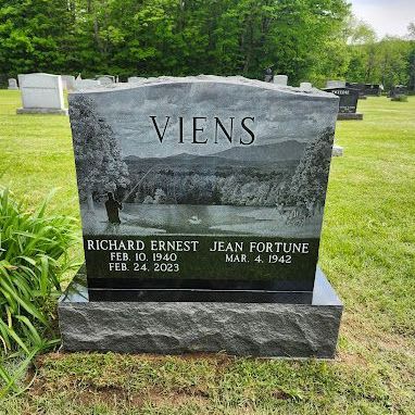 A gravestone for richard ernest jean fortune is in a cemetery.