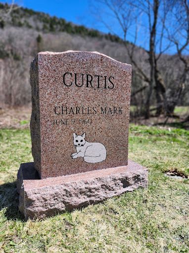 A woman is putting flowers in a vase on a table.