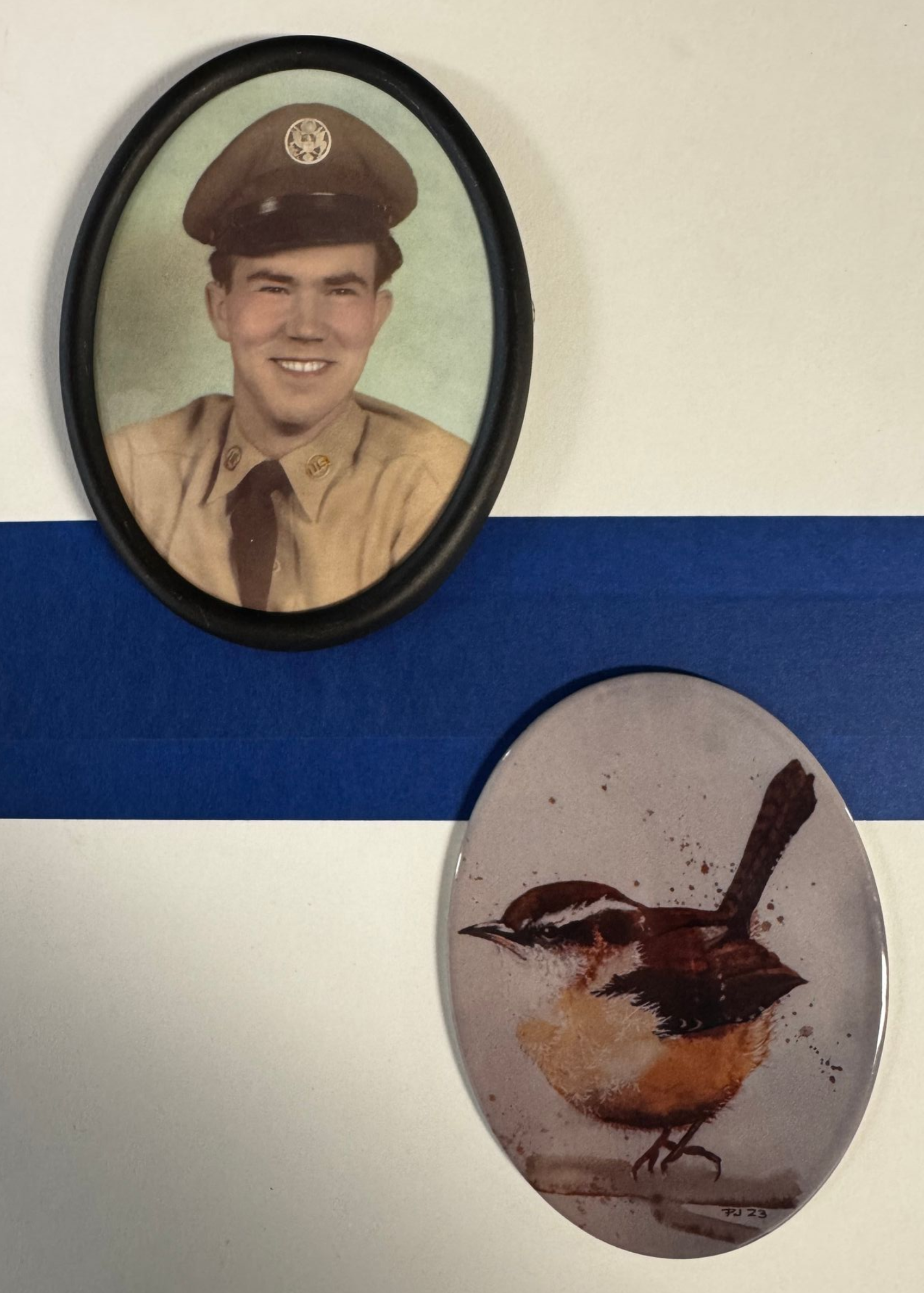 A red rose is laying on top of a grave.