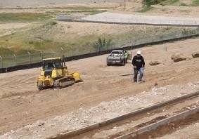 Front Loader And Man Walking In Construction Site — El Paso, TX — Aquatech Septic & Underground, LLC