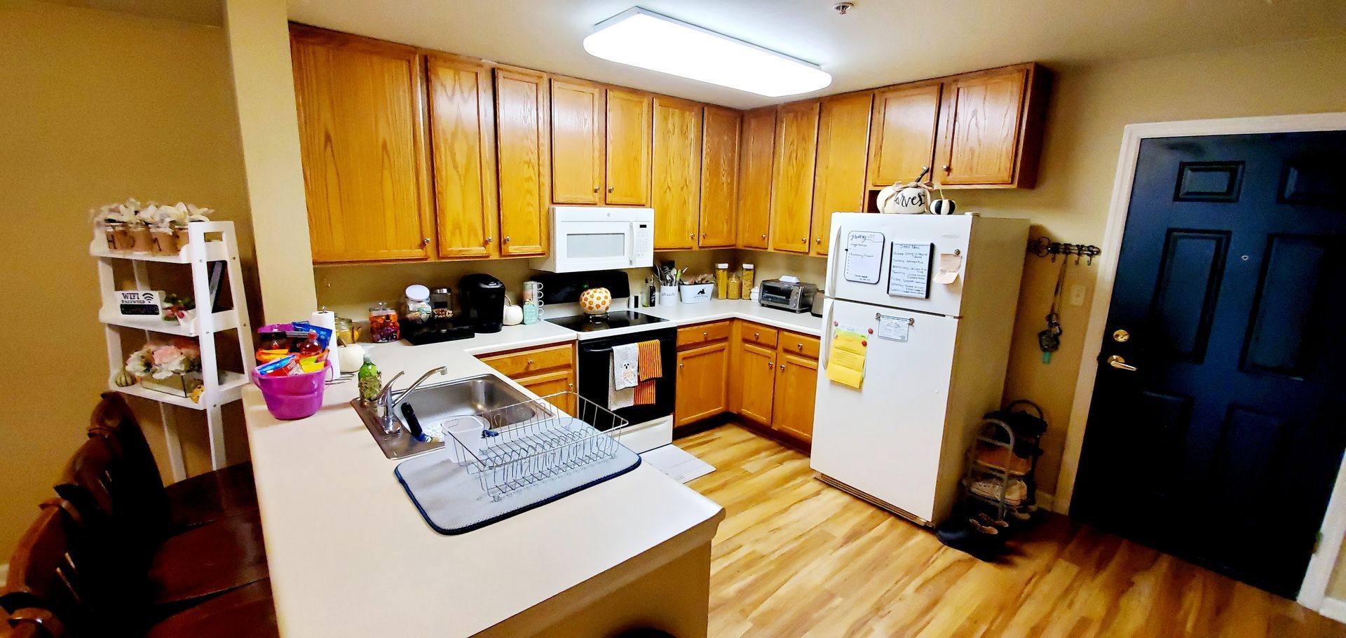 A kitchen with wooden cabinets and a white refrigerator.