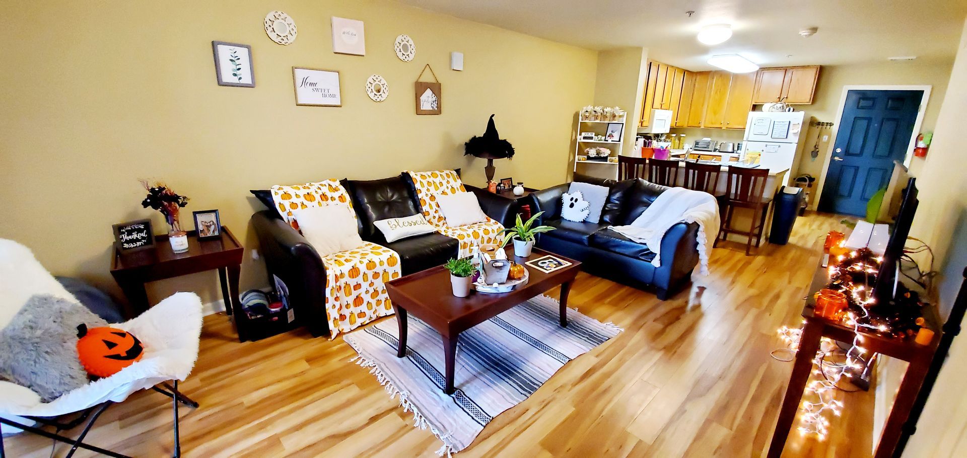 A living room filled with furniture and a table with a pumpkin on it.
