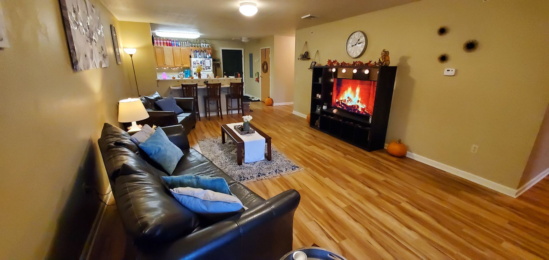 A living room with a couch , chairs , and a fireplace.