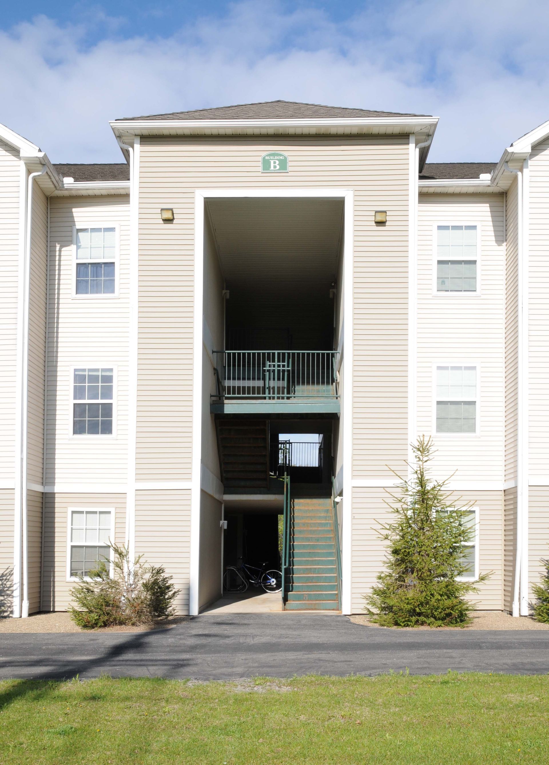 A large apartment building with stairs leading up to the second floor