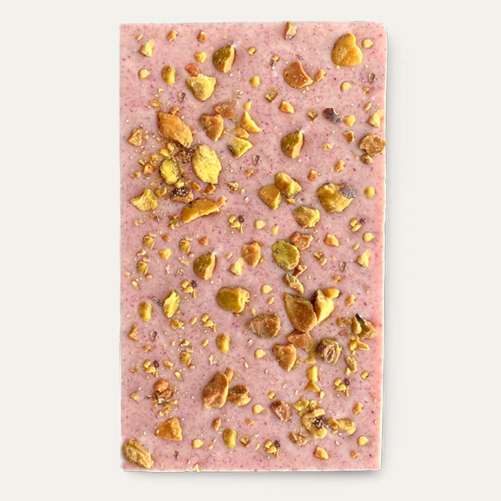 light pink white chocolate bar with pistachio toppings