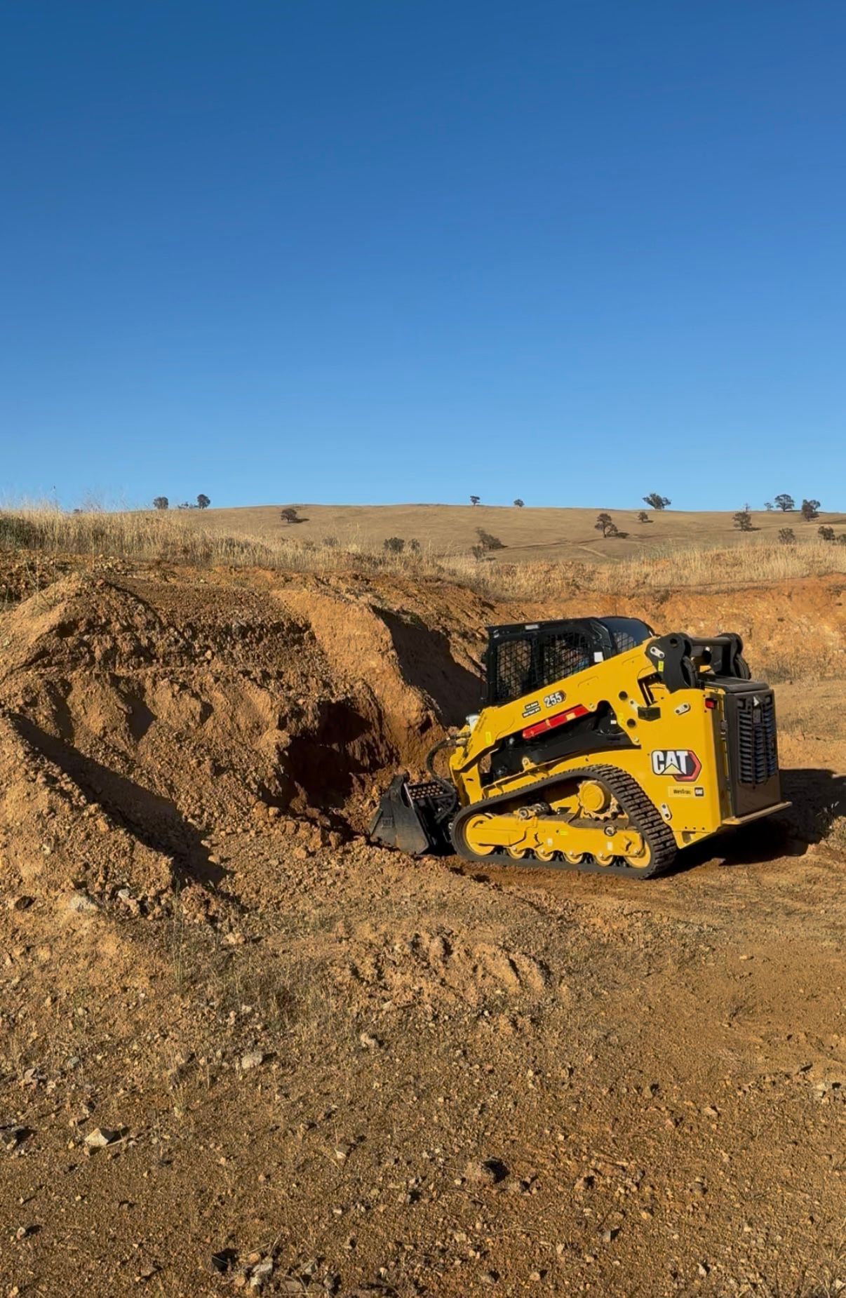 Rural earthworks in Cowra NSW – Posi Track loading farm gravel for site prep and efficient material handling.