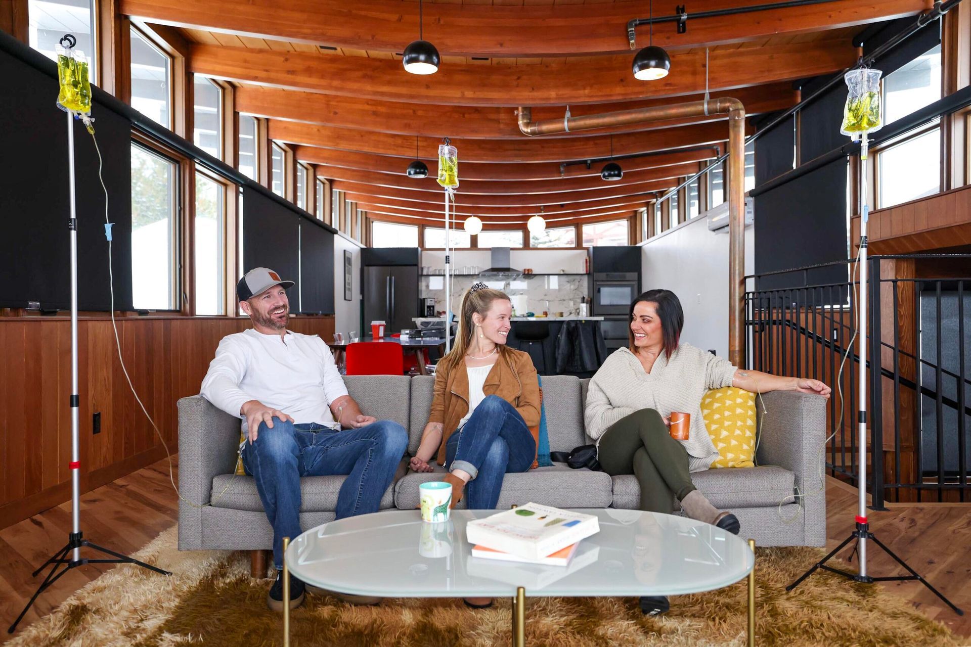 A group of people are sitting on a couch in a living room.