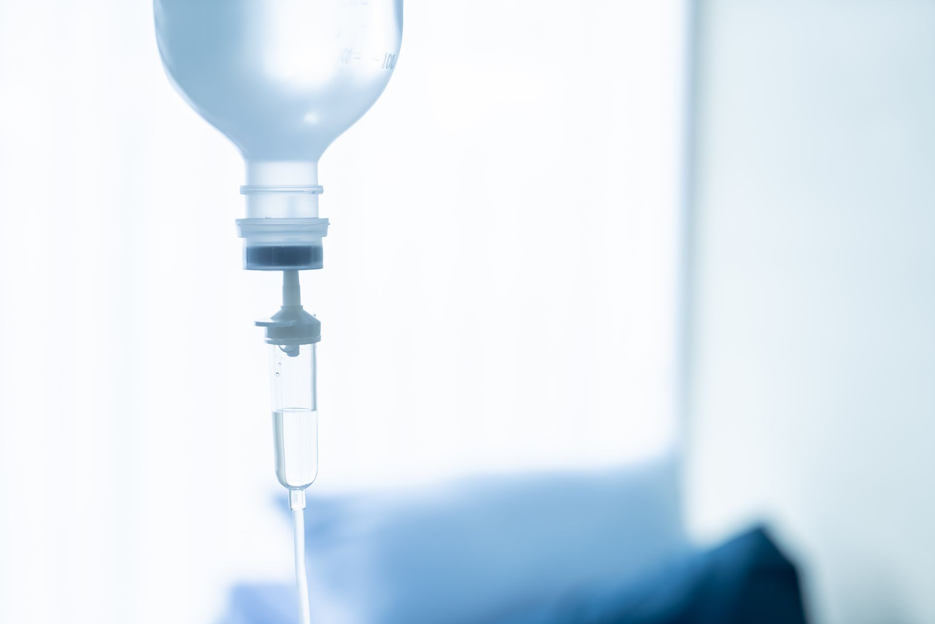 A close up of an iv drip in a hospital room.