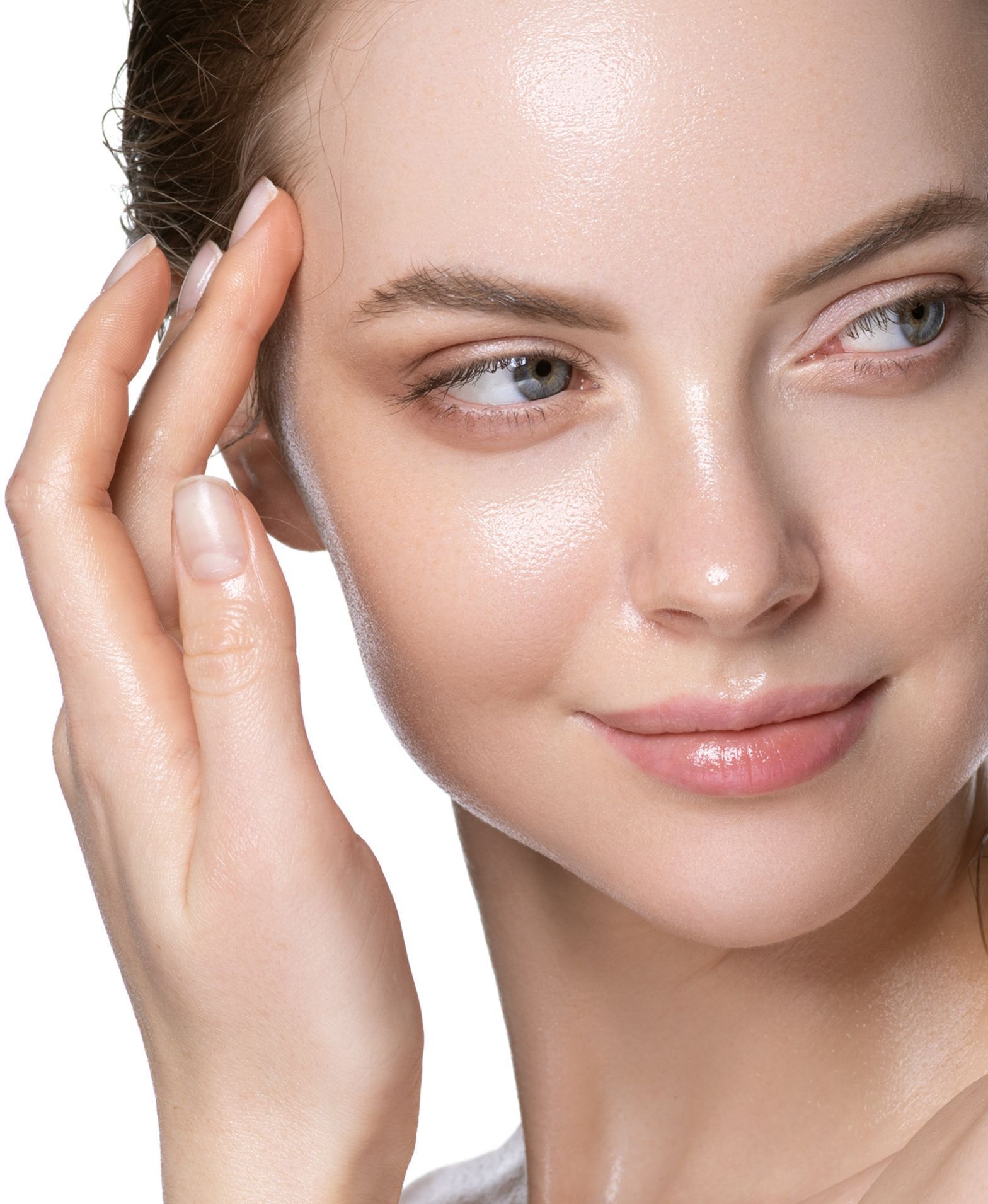 A close up of a woman 's face with her hand on her forehead