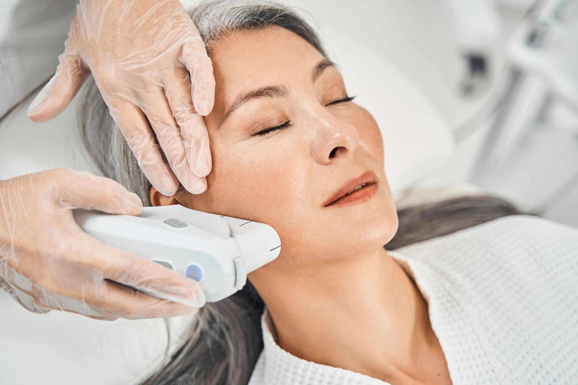 A woman is getting a facial treatment at a beauty salon.