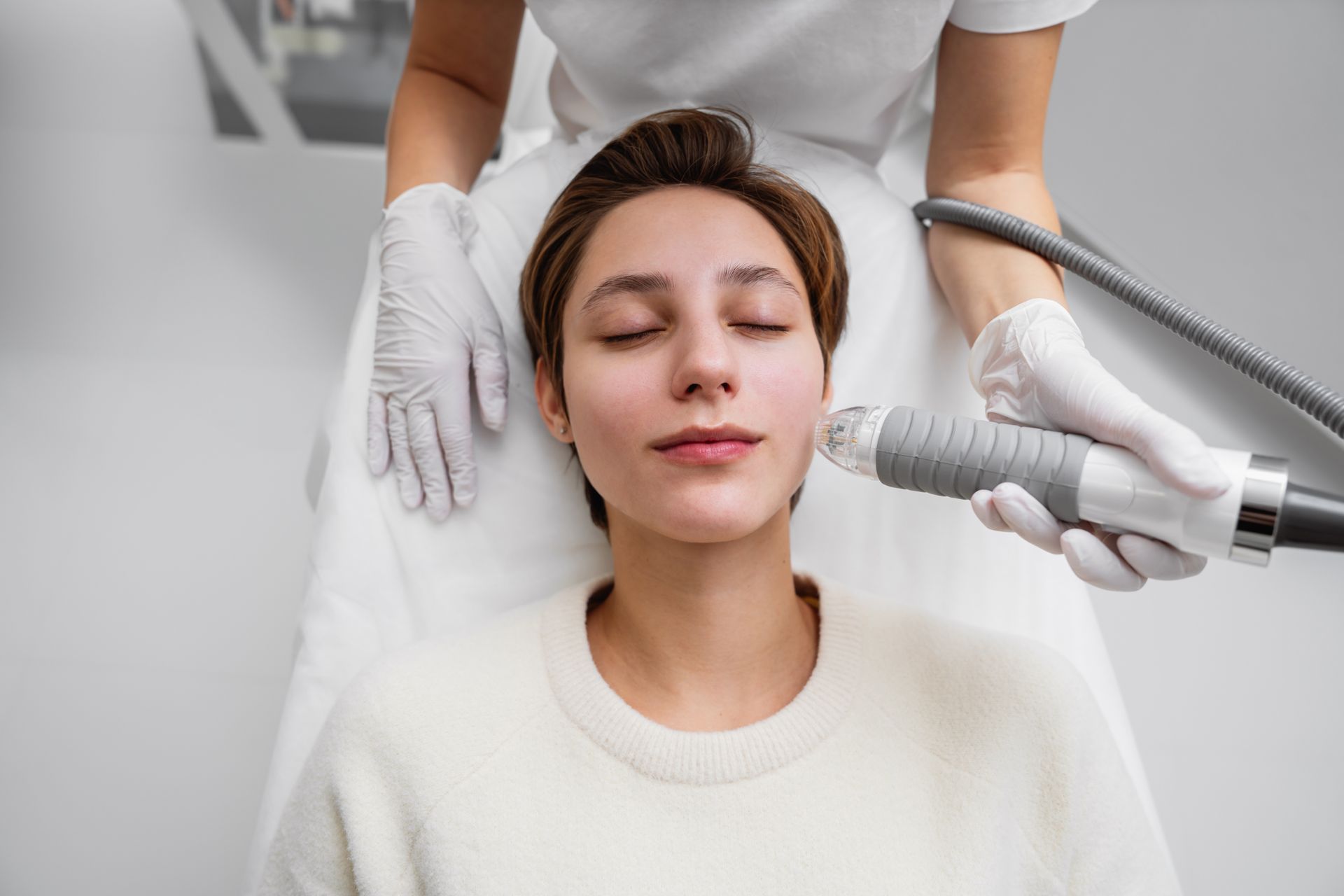 A woman is getting a facial treatment in a beauty salon.