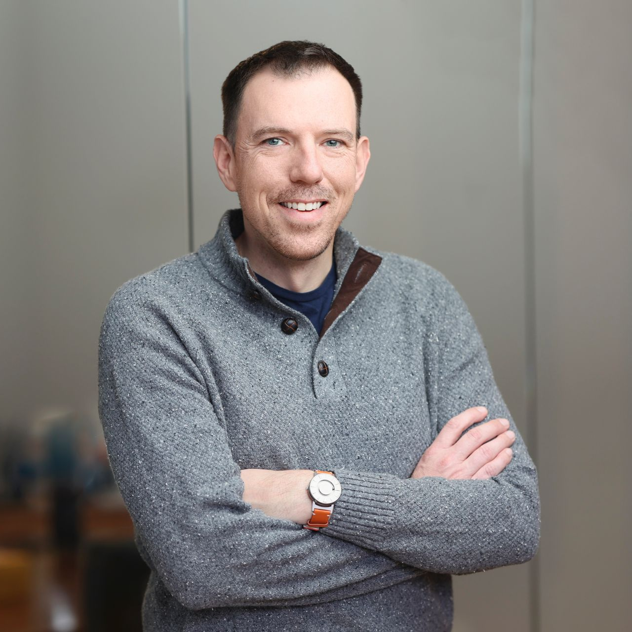 a personal injury attorney in a suit and tie is adjusting his cufflinks