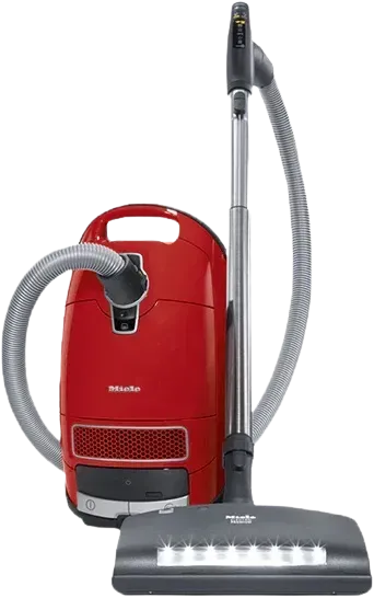 Red upright vacuum cleaner with gray hose and floor nozzle on a white background