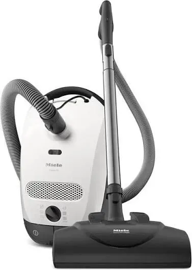 White and gray canister vacuum cleaner with hose and floor head on a white background