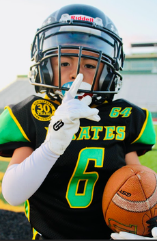 A young football player with the number 6 on his jersey