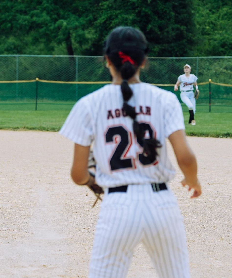 A baseball player with the number 29 on the back of her jersey