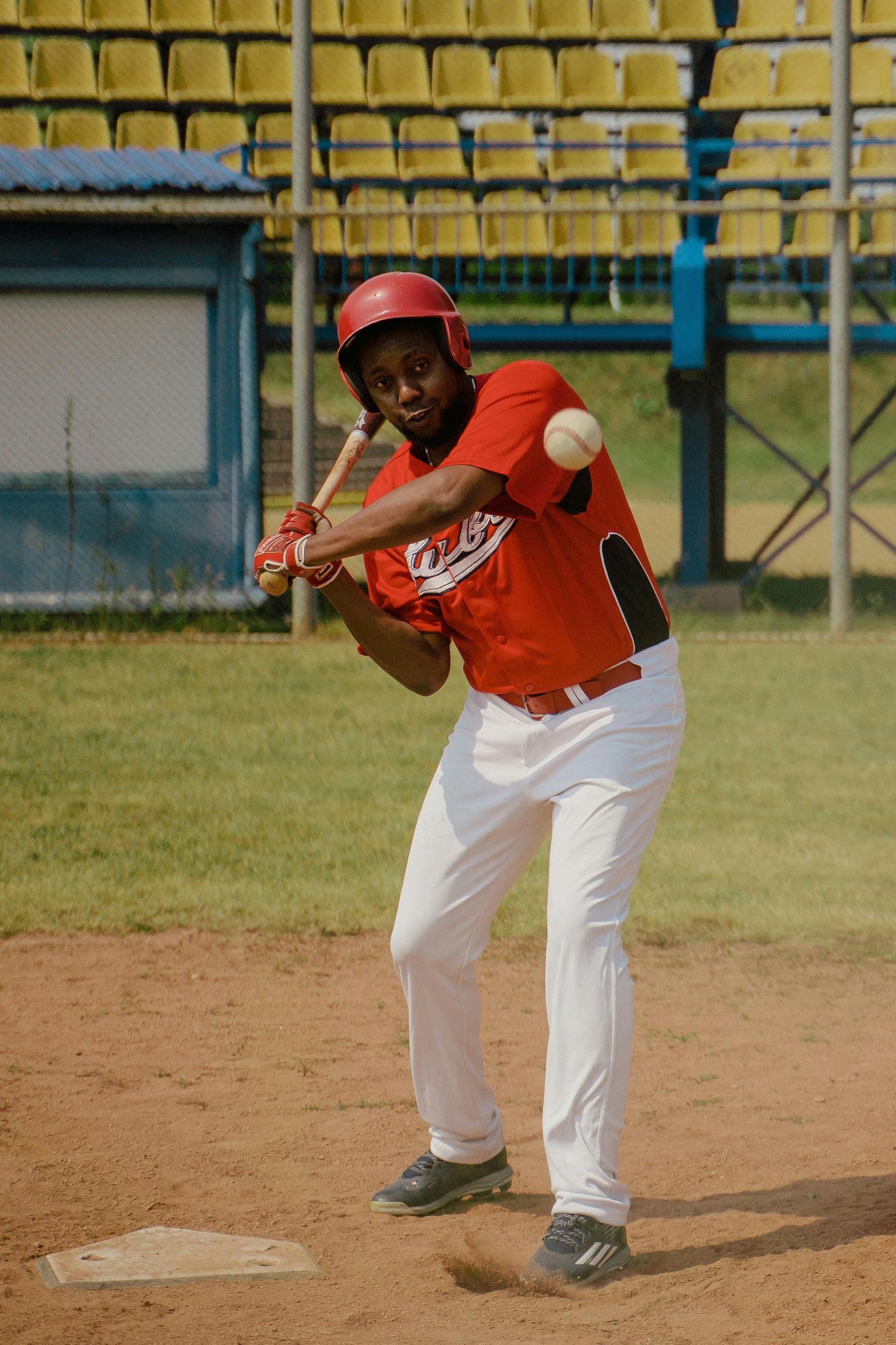 A baseball player is swinging a bat at a ball on a field.