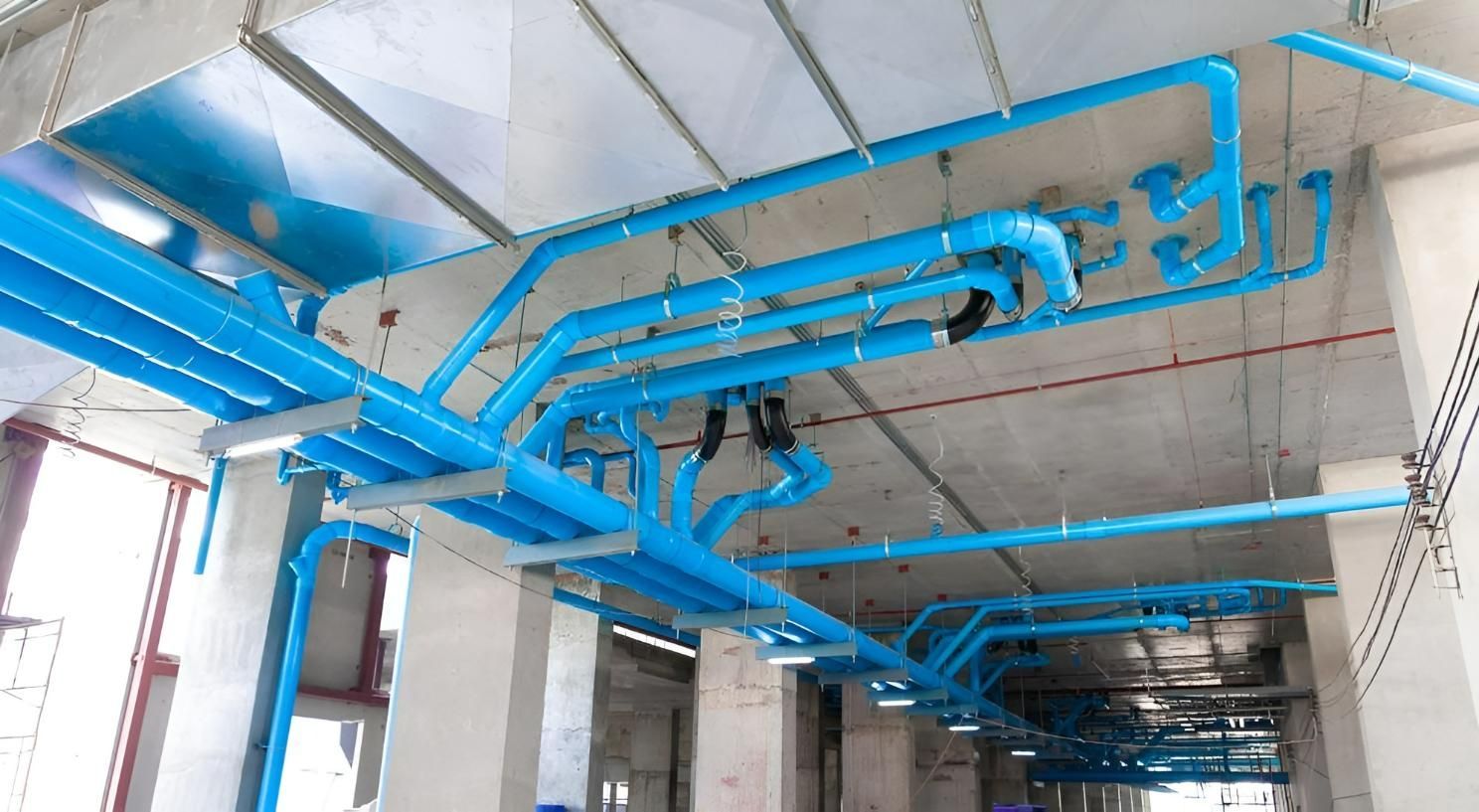 A Bunch of Blue Pipes Are Hanging from The Ceiling of A Building — Top To Bottom Plumbing in Garbutt, QLD