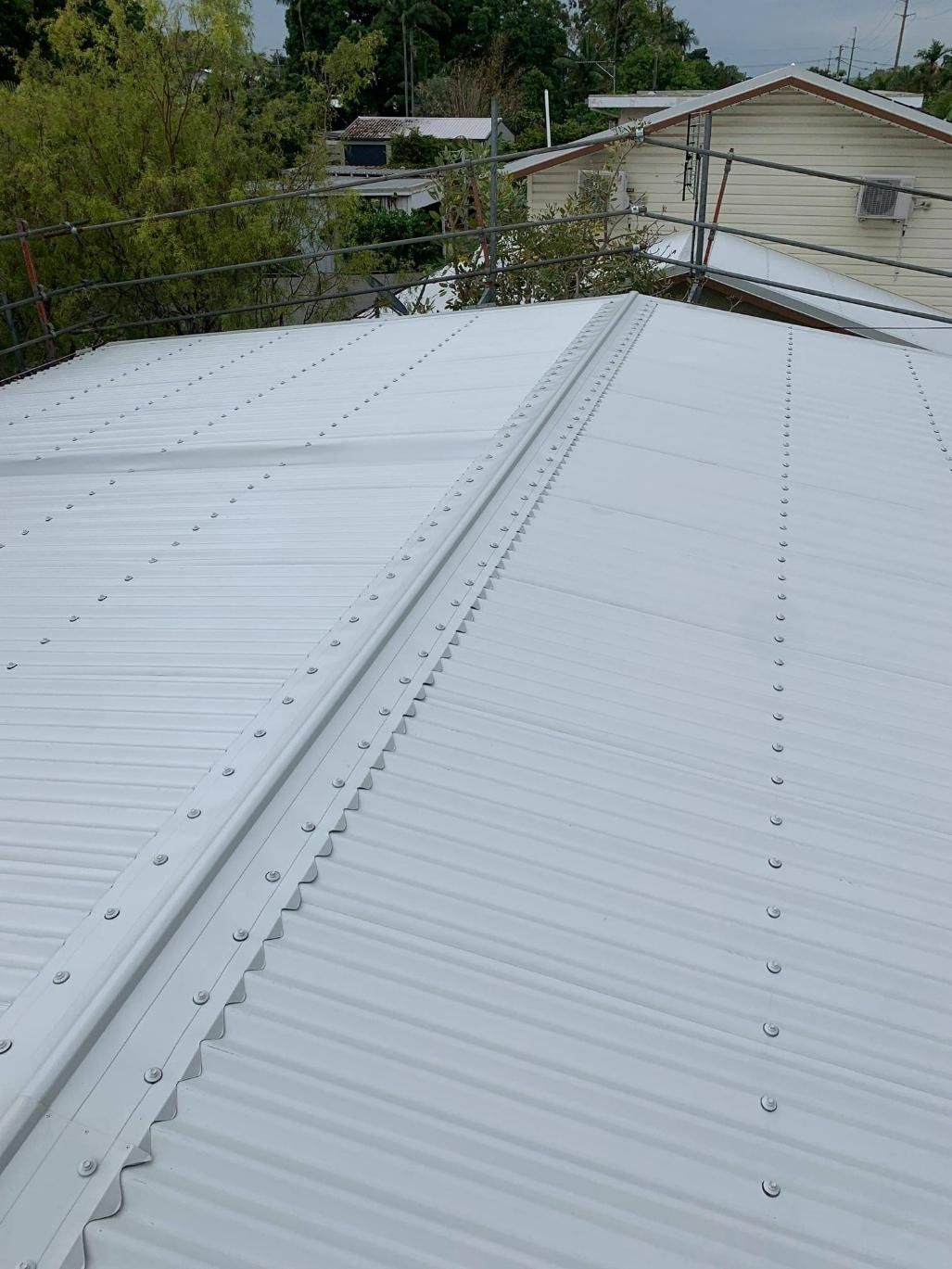 A White Roof of A House with Trees in The Background — Top To Bottom Plumbing in Garbutt, QLD