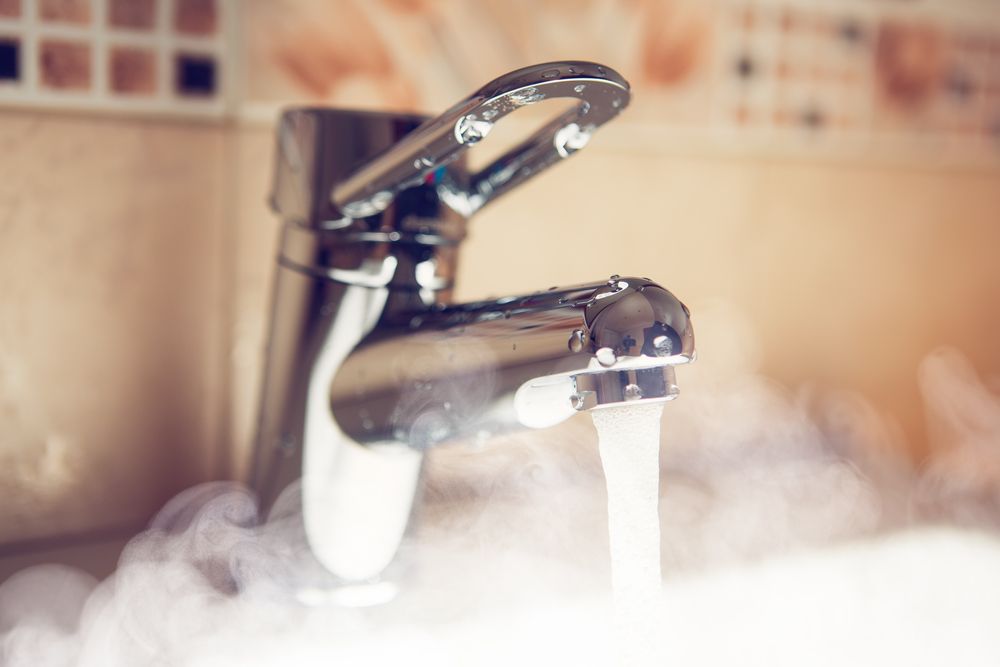 A running tap in a bathroom setting.