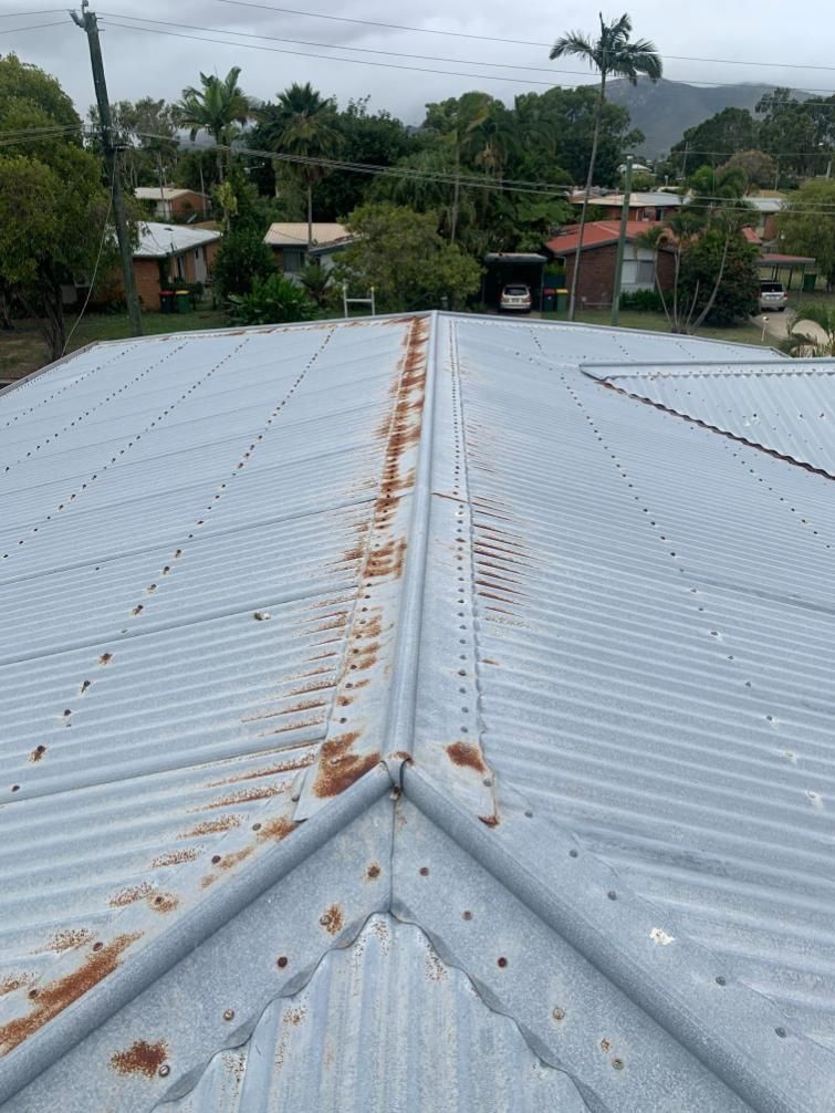 A Roof with A Lot of Rust on It and A Lot of Trees in The Background — Top To Bottom Plumbing in Garbutt, QLD
