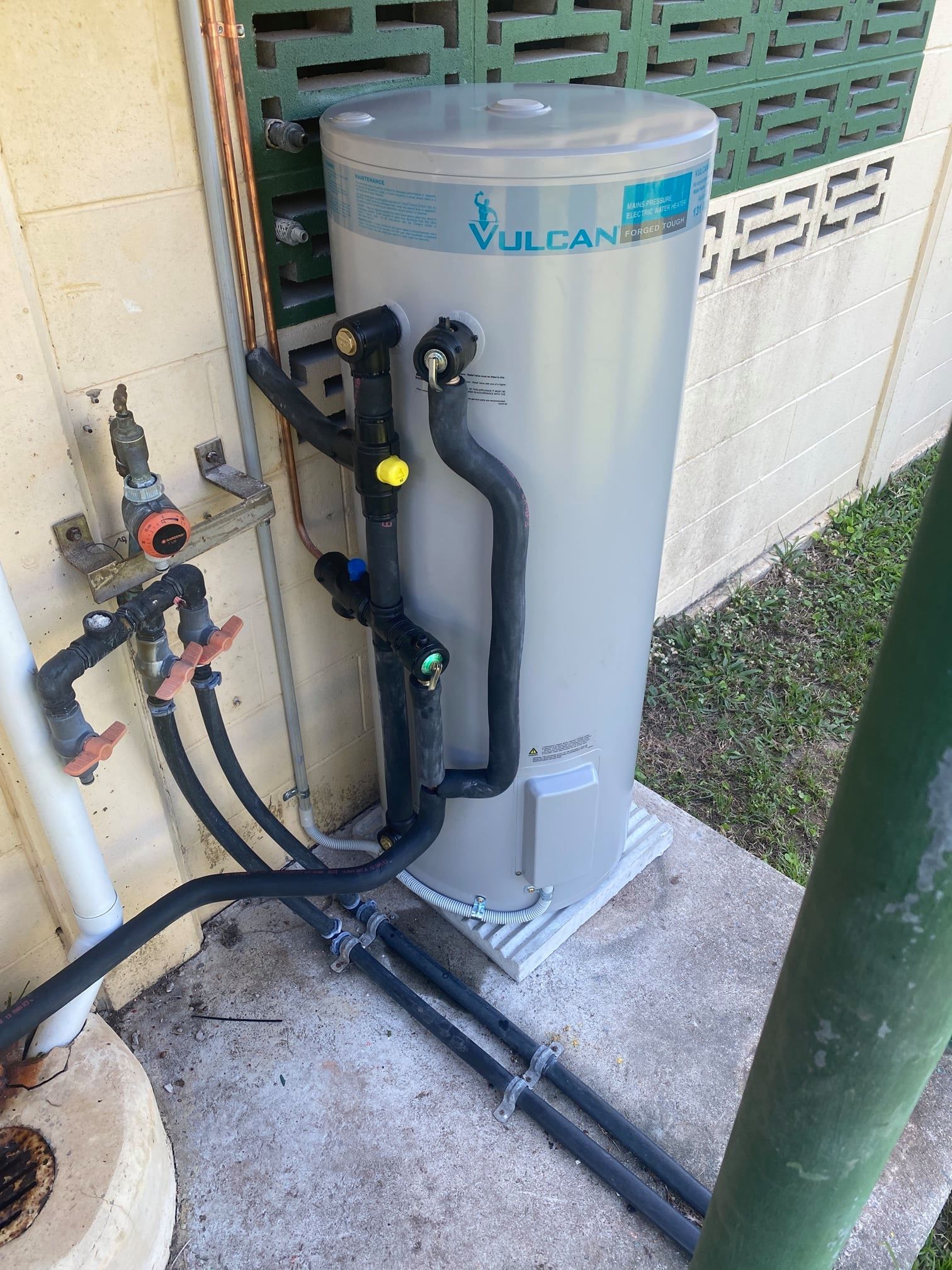 A Vulcan Hot Water System, Gray Tank With Black Pipes — Top To Bottom Plumbing in Garbutt, QLD