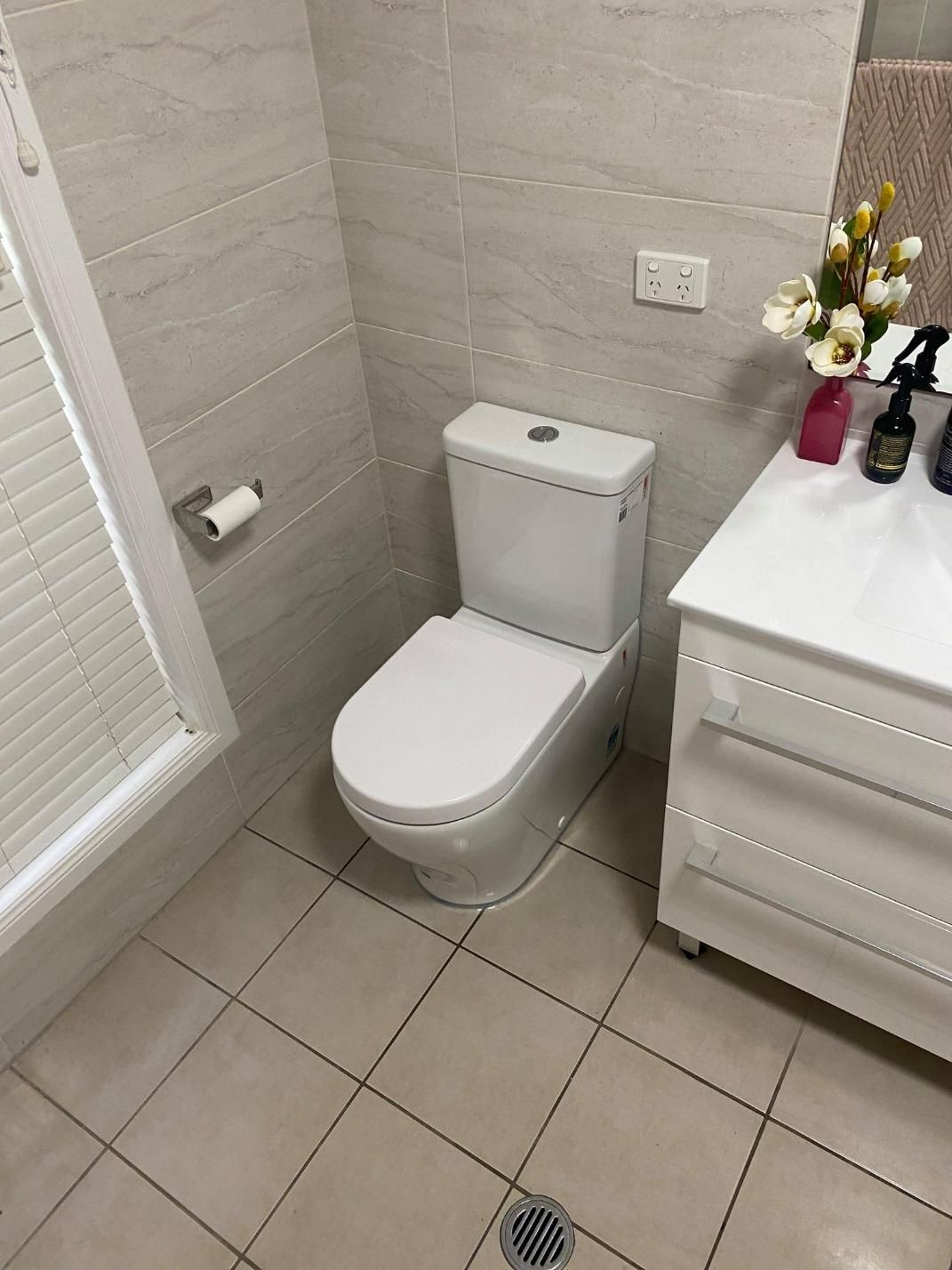 A Bathroom with A Toilet, Sink, and Shower — Top To Bottom Plumbing in Garbutt, QLD