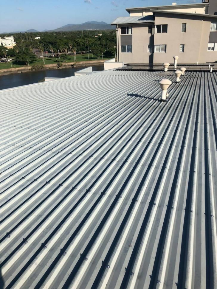 A Roof with A Lot of Lines on It and A Building in The Background — Top To Bottom Plumbing in Garbutt, QLD