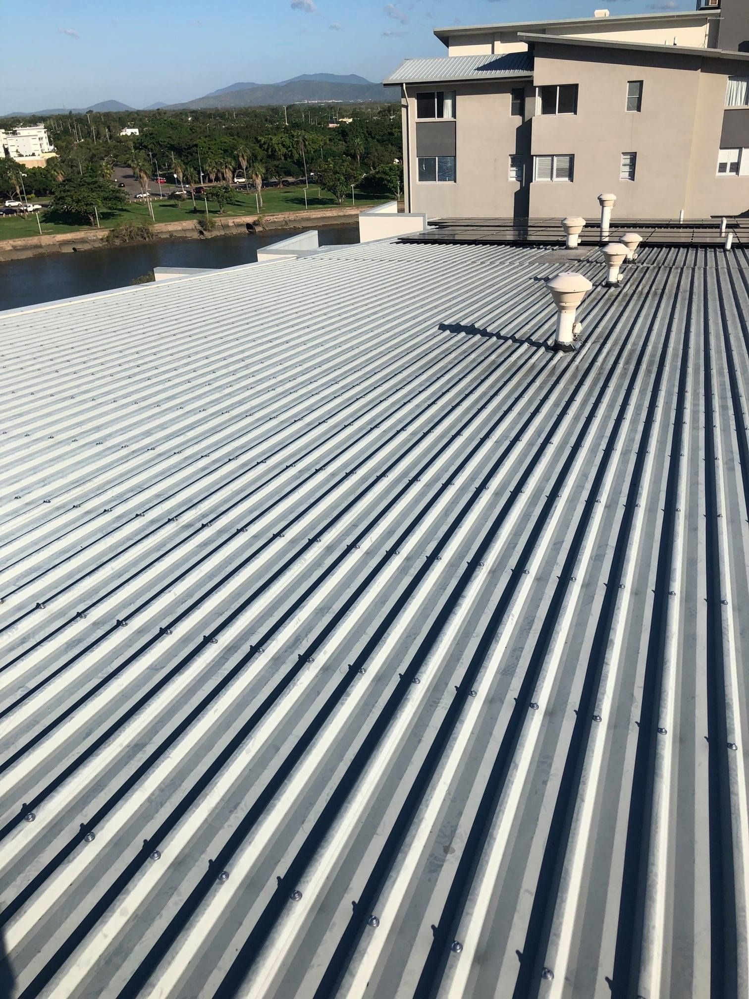 View of a Corrugated Metal Roof on a Building With Ventilation Pipes — Top To Bottom Plumbing in Garbutt, QLD