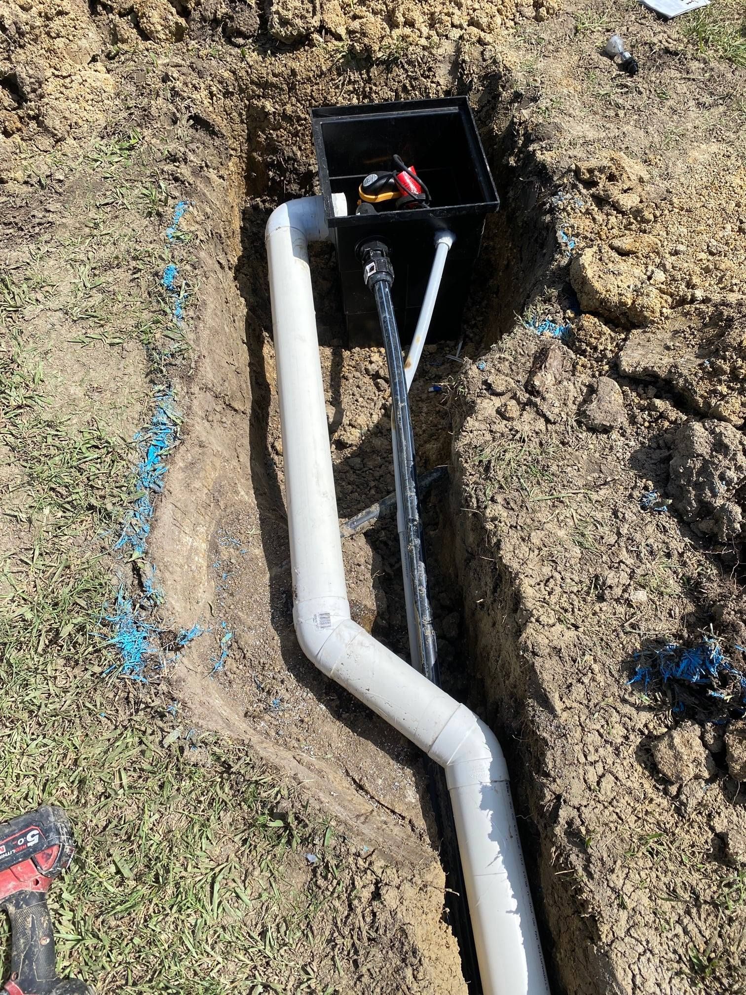 White PVC Pipe in a Trench Connected to a Black Box, — Top To Bottom Plumbing in Garbutt, QLD
