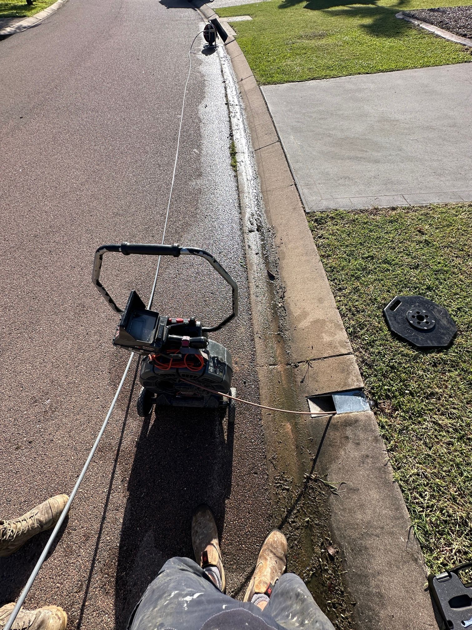 A Man Is Fixing a Pipe with A Wrench — Top To Bottom Plumbing in Garbutt, QLD