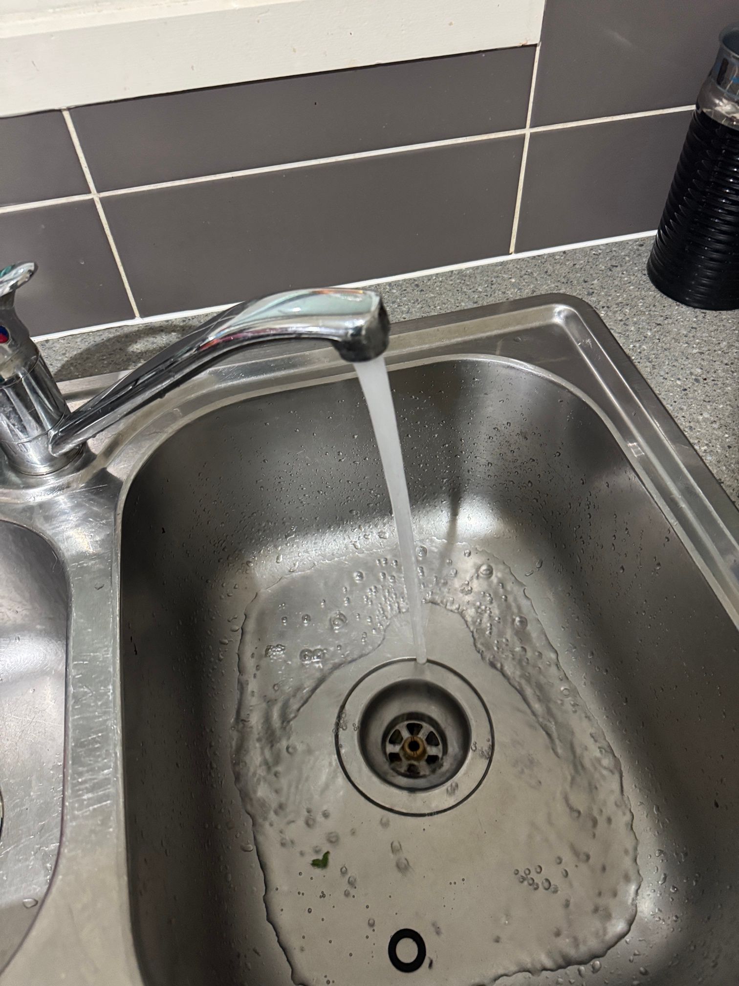 A Sink with A Plunger Sticking out Of It — Top To Bottom Plumbing in Garbutt, QLD
