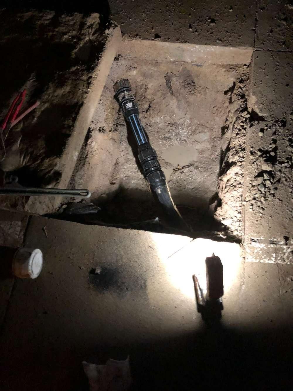 A Flashlight Is Sitting on The Ground in A Dark Room — Top To Bottom Plumbing in Garbutt, QLD