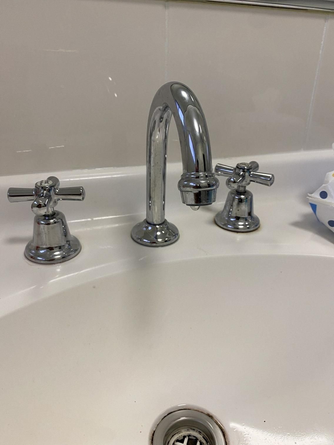 A Close up Of a Bathroom Sink with Chrome Faucets — Top To Bottom Plumbing in Garbutt, QLD