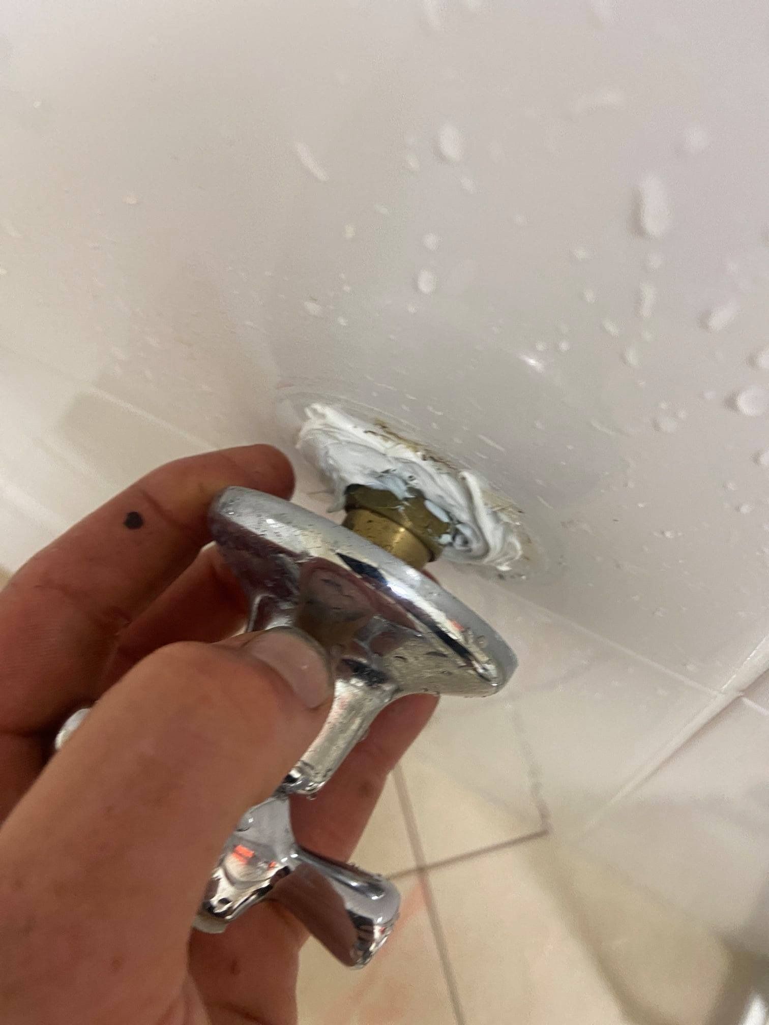 Plumber Inspecting Possible Water Leak on Faucet