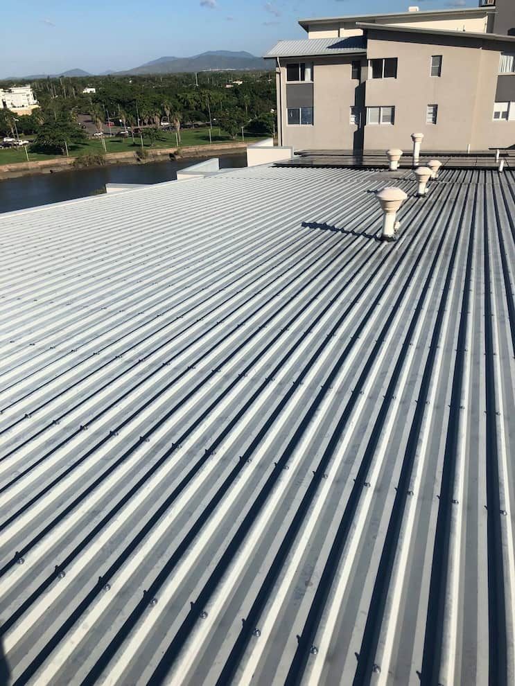 Rooftop View of a Corrugated Metal Roof With Several Vent Pipes