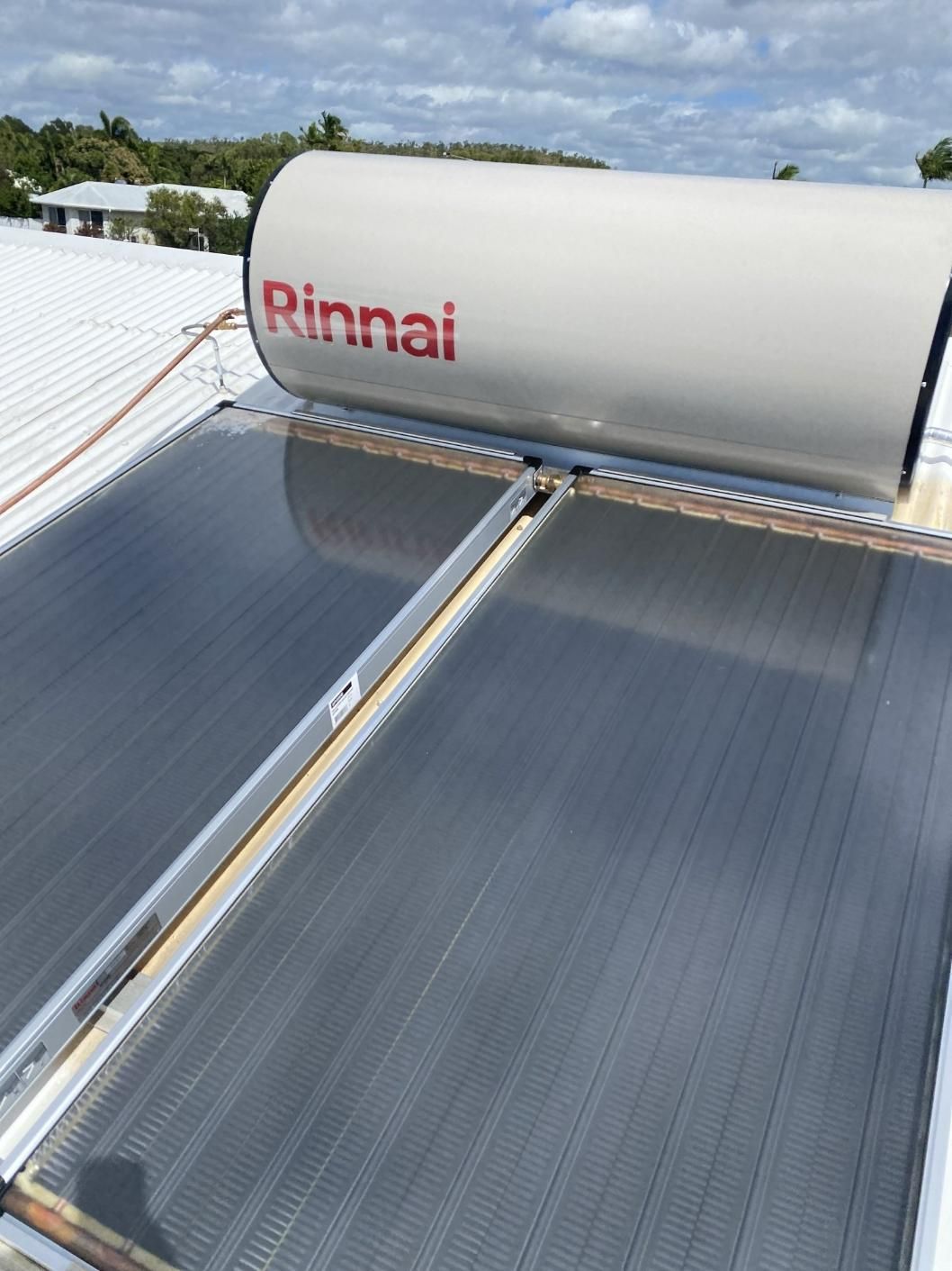 A Rinnai Water Heater Is Sitting on Top of A Roof — Top To Bottom Plumbing in Garbutt, QLD