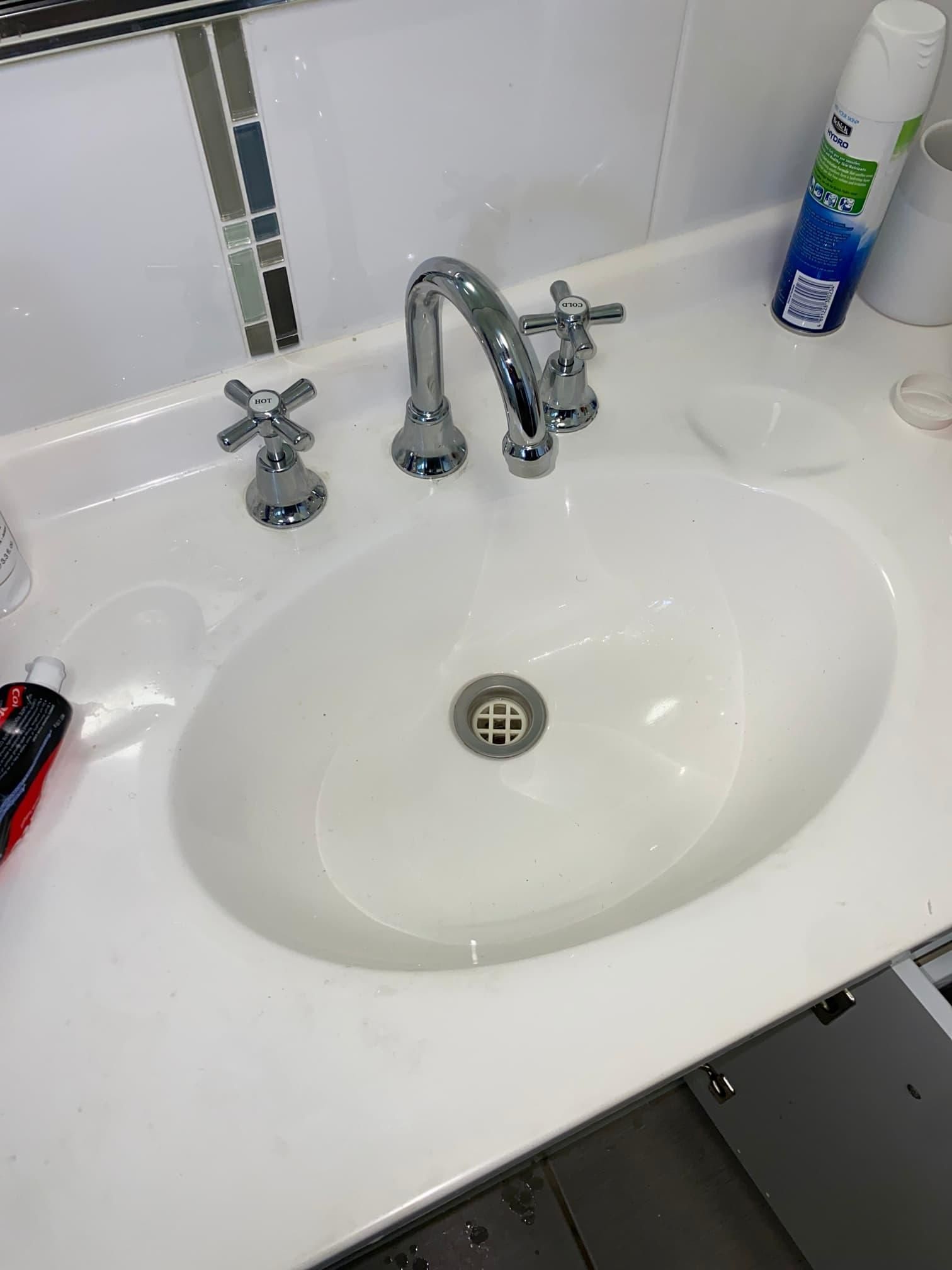 A Bathroom Sink with A Faucet and A Spray Bottle on The Counter — Top To Bottom Plumbing in Garbutt, QLD