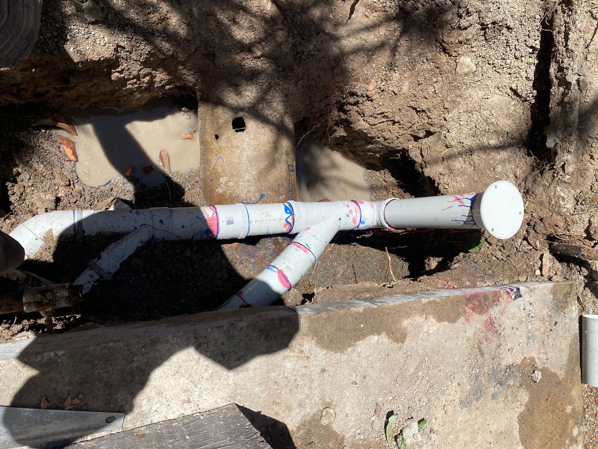 Two Pipes Are Connected to Each Other in A Trench — Top To Bottom Plumbing in Garbutt, QLD
