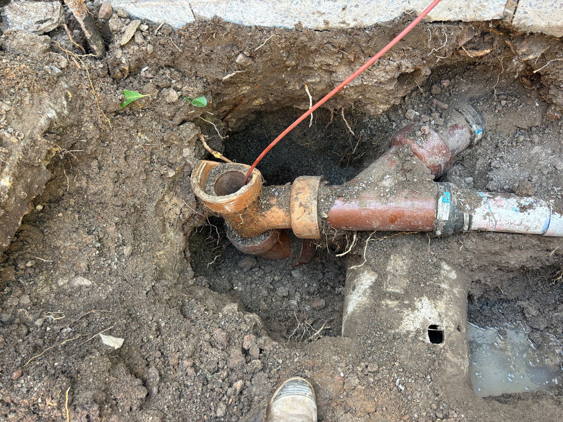 excavated ground revealing damaged underground pipes during a plumbing upgrade in Townsville 