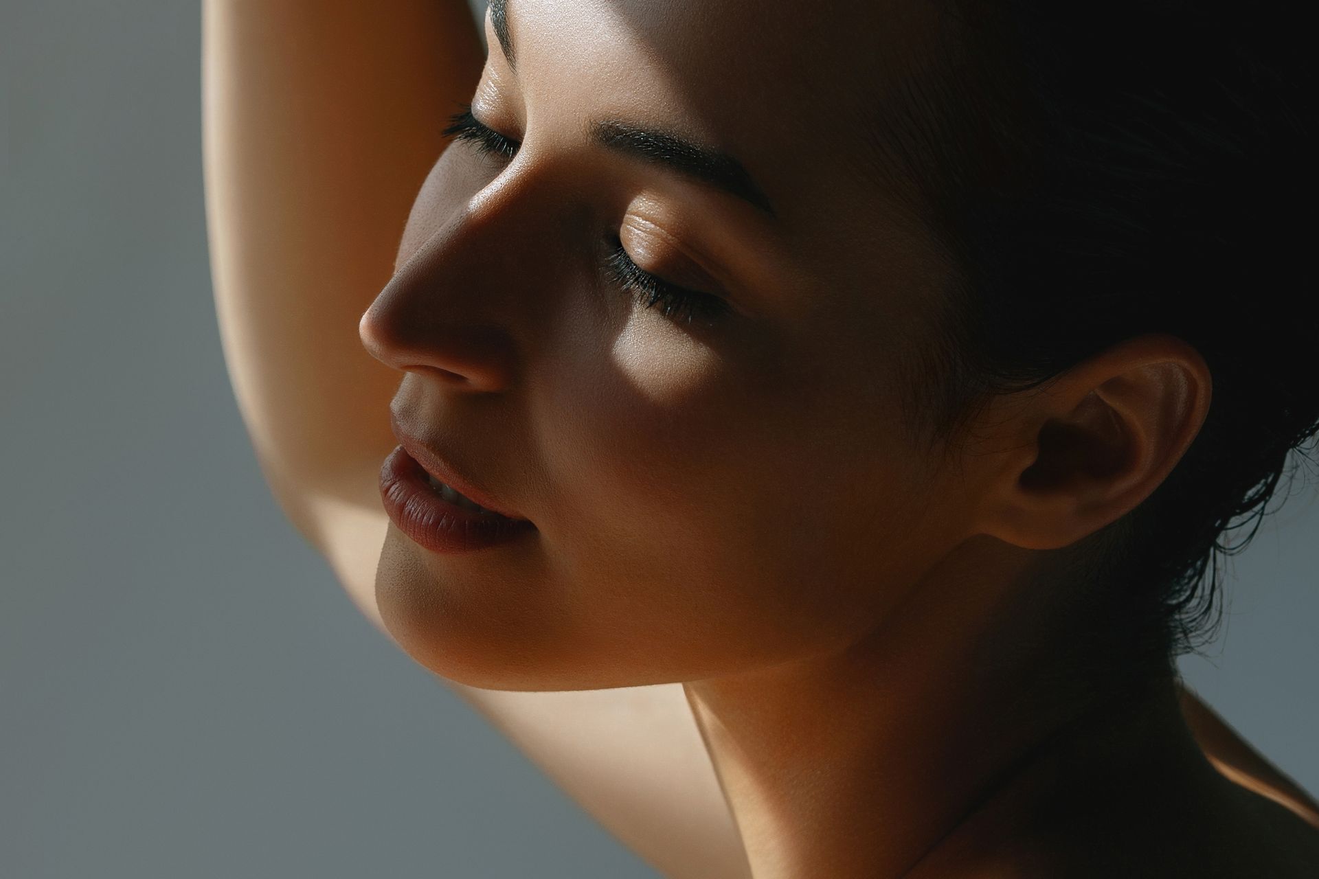 A close up of a woman 's face with the sun shining on it.